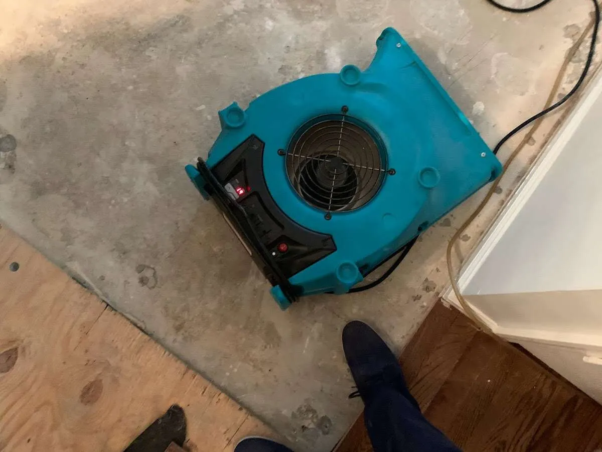 Air mover drying subfloor during Commercial Water Damage Restoration in Ivins